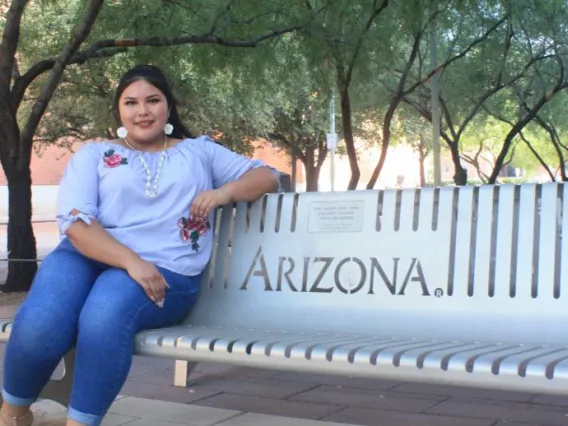 Amy Spotted Wolf on a UA bench