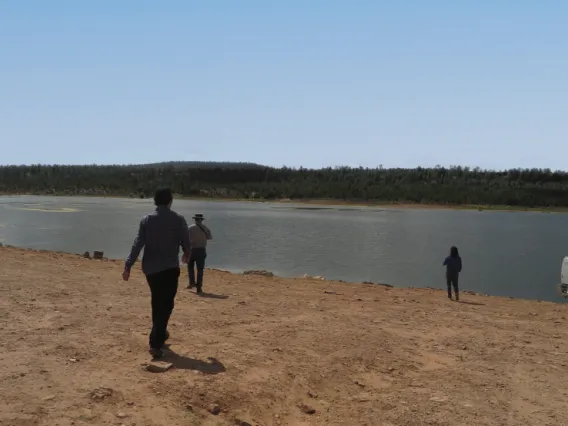 people by a shallow body of water