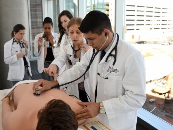 medical students check for life signs on a dummy