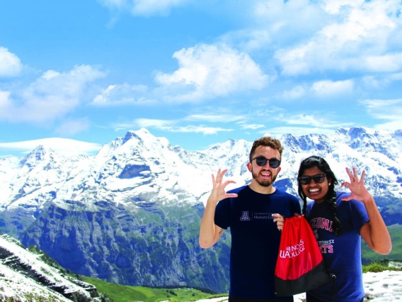 two students in front of some mountains
