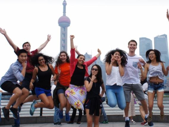 international students posing in front of a tower