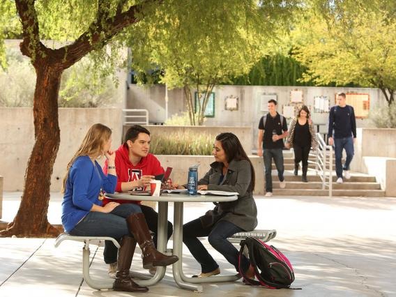 students at a table outside