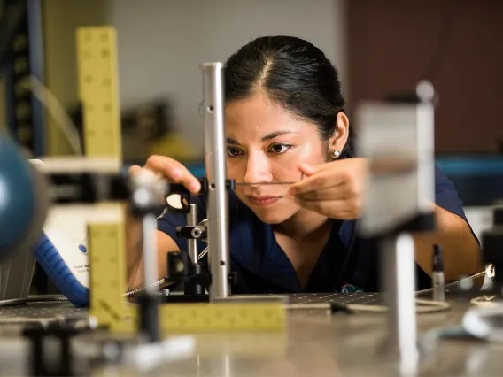 Student focuses intently on a robotics project