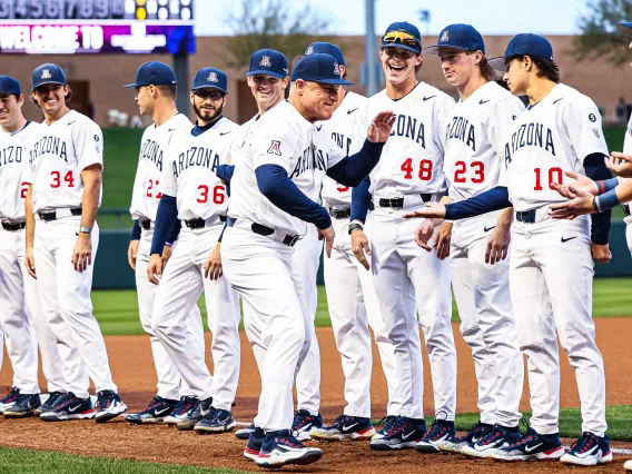 A photograph of UArizona Baseball team celebrating with their coach