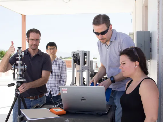 A photograph of Professor R. Jason Jones working with a research group