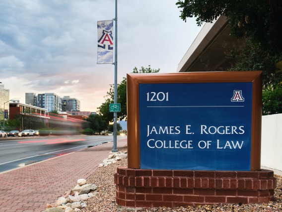 A photograph of the James E. Rogers College of Law signage, onlooking the street 