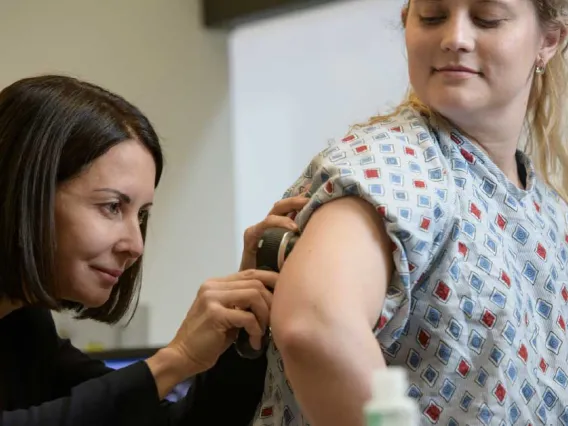 A photograph of a woman being examined by a doctor