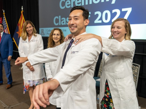 A photograph of The Class of 2027 receiving their first white coats