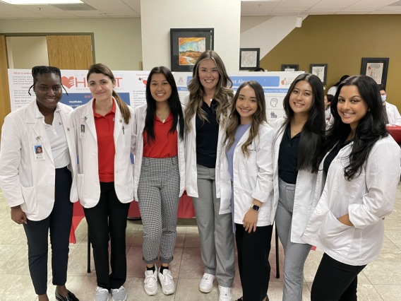 A group of students standing together with their pharmacy coats on 