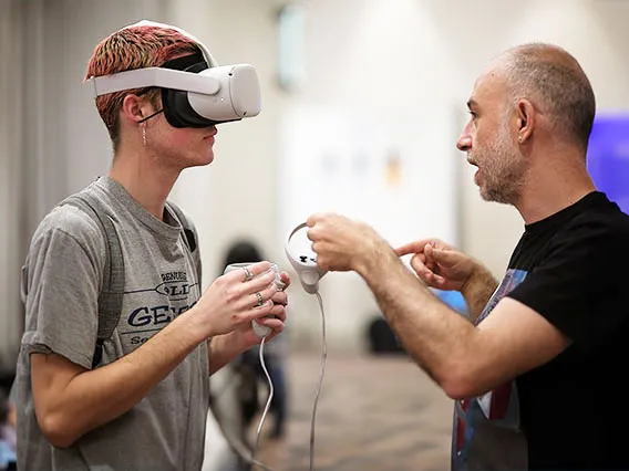 A photograph of an instructor leading a student with a virtual reality headset 