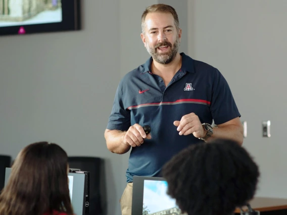 An instructor speaking to a group of students