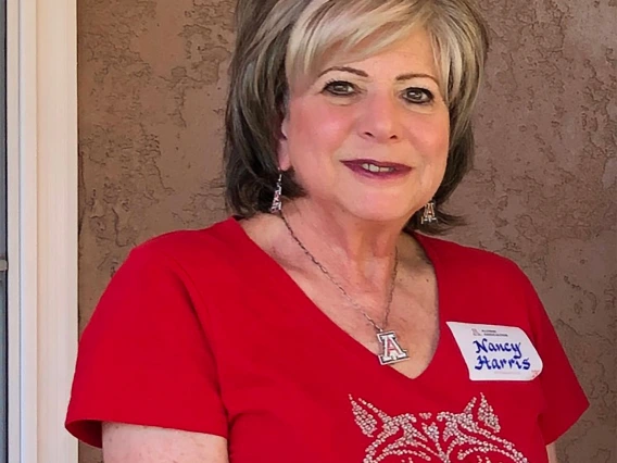 Nancy Harris wearing a red Wildcat shirt smiling 