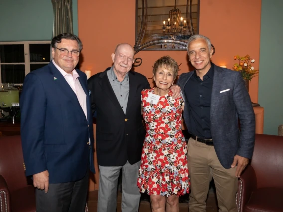 Michael Abecassis, Tom Rogers, Ginny L. Clements and Hesham Sadek standing arm in arm and smiling. 