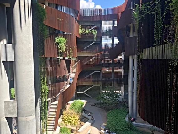 An aerial view of a building with winding stairs and plants surrounding it
