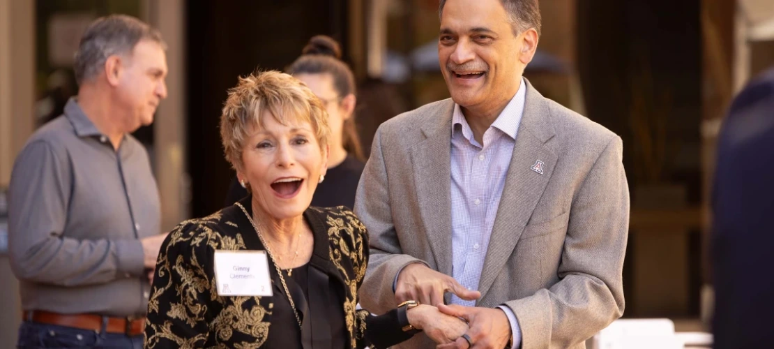 A man holding a woman's hand and laughing 