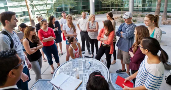 students gathered in a circle outside