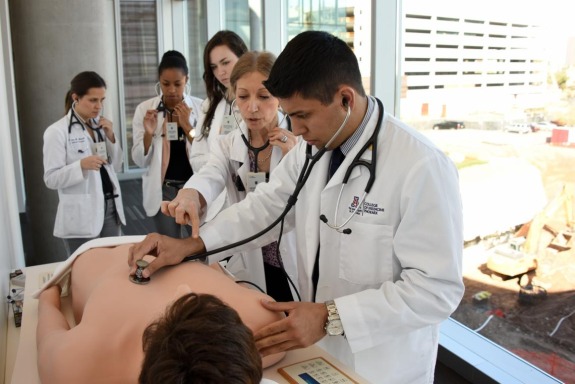 medical students check for life signs on a dummy