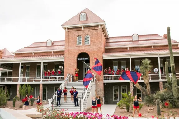 old main with a band and cheer squad