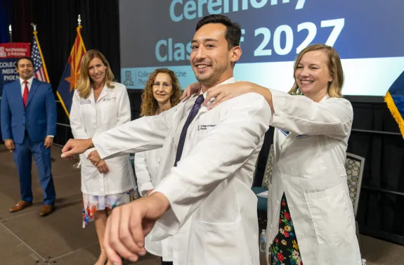 A photograph of The Class of 2027 receiving their first white coats