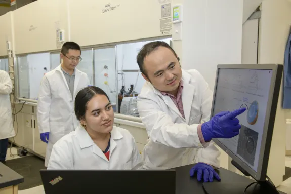 A photograph of two individuals working in the R. Ken Coit College of Pharmacy