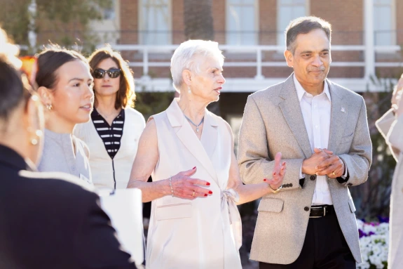 President Garimella standing and speaking with Pat Gerleman and other staff members in front of Old Main 