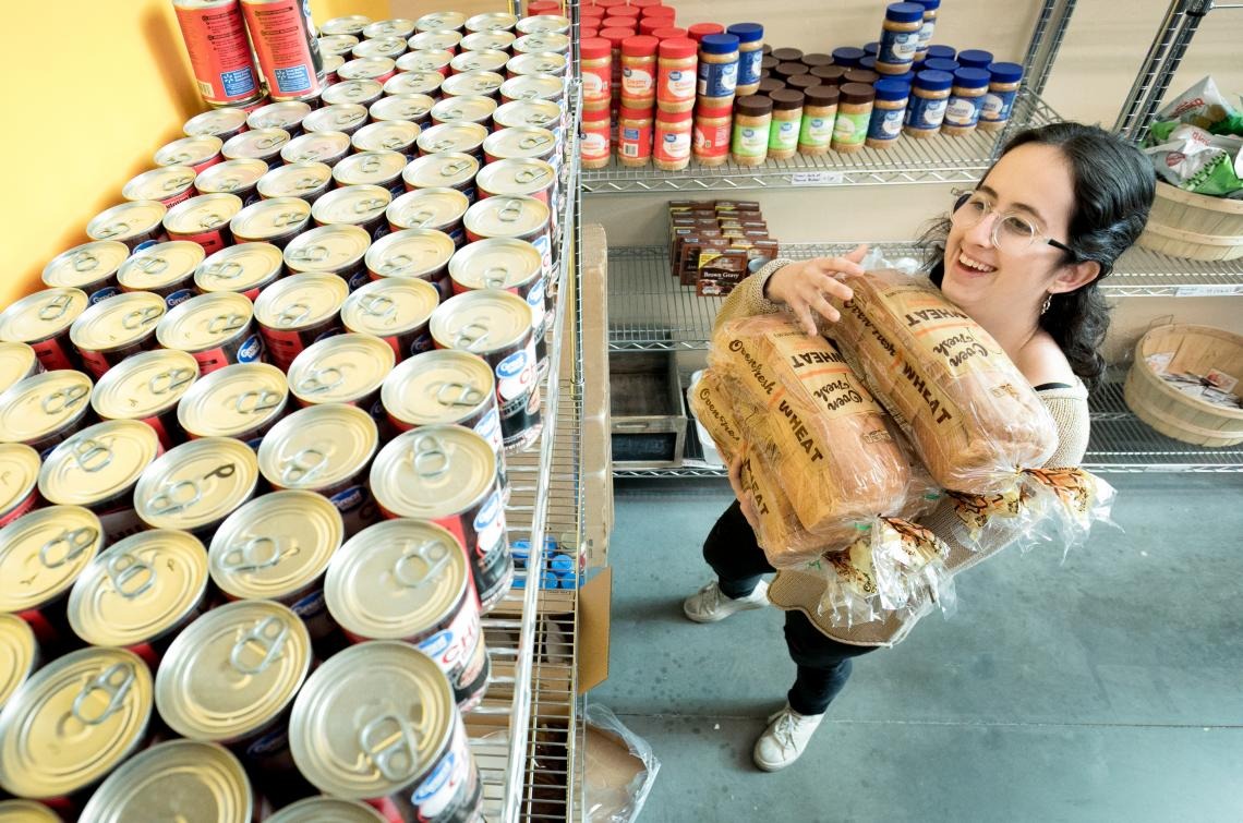 Student stocking a pantry