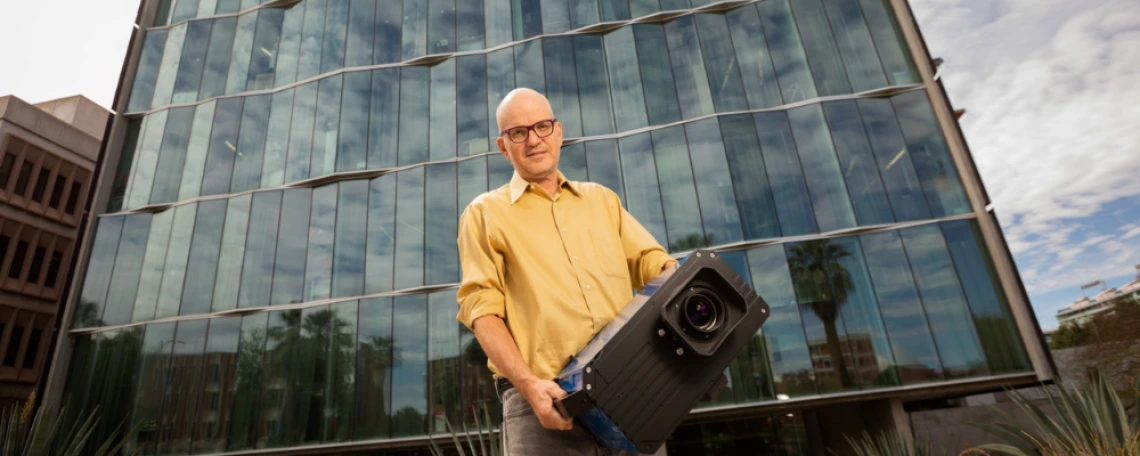 man holding projector