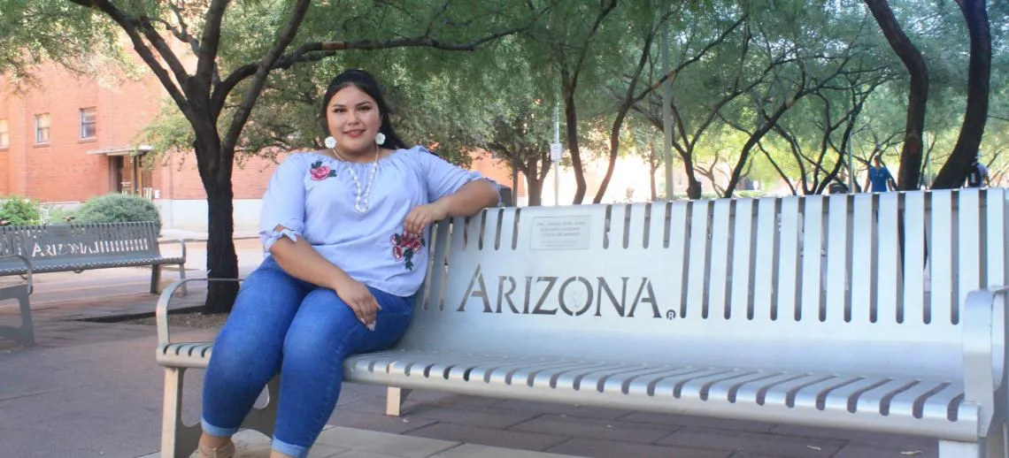 Amy Spotted Wolf on a UA bench