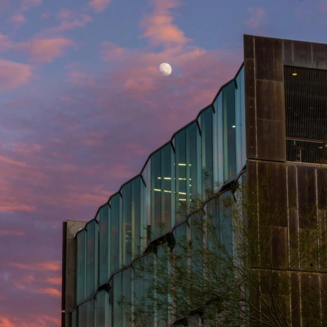 moon in the sky over a building