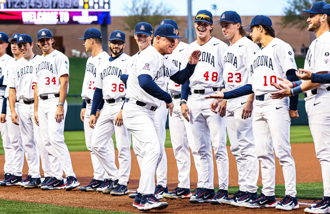 A photograph of UArizona Baseball team celebrating with their coach