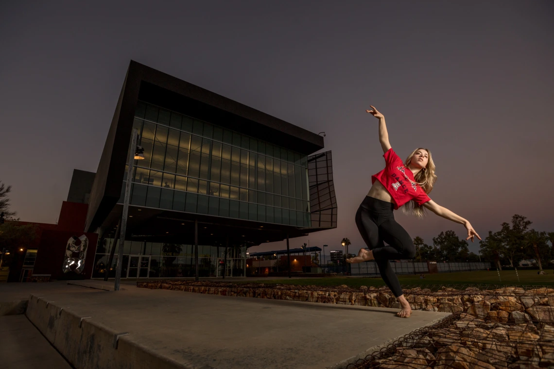 Student dances in front of the School of Dance