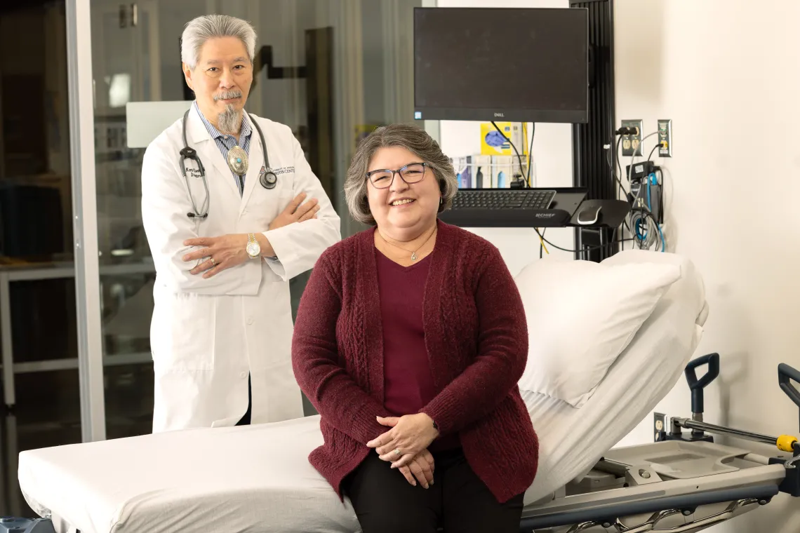 Arthritis Center Director C. Kent Kwoh and Loretta Pedraza in a UAAC patient exam room