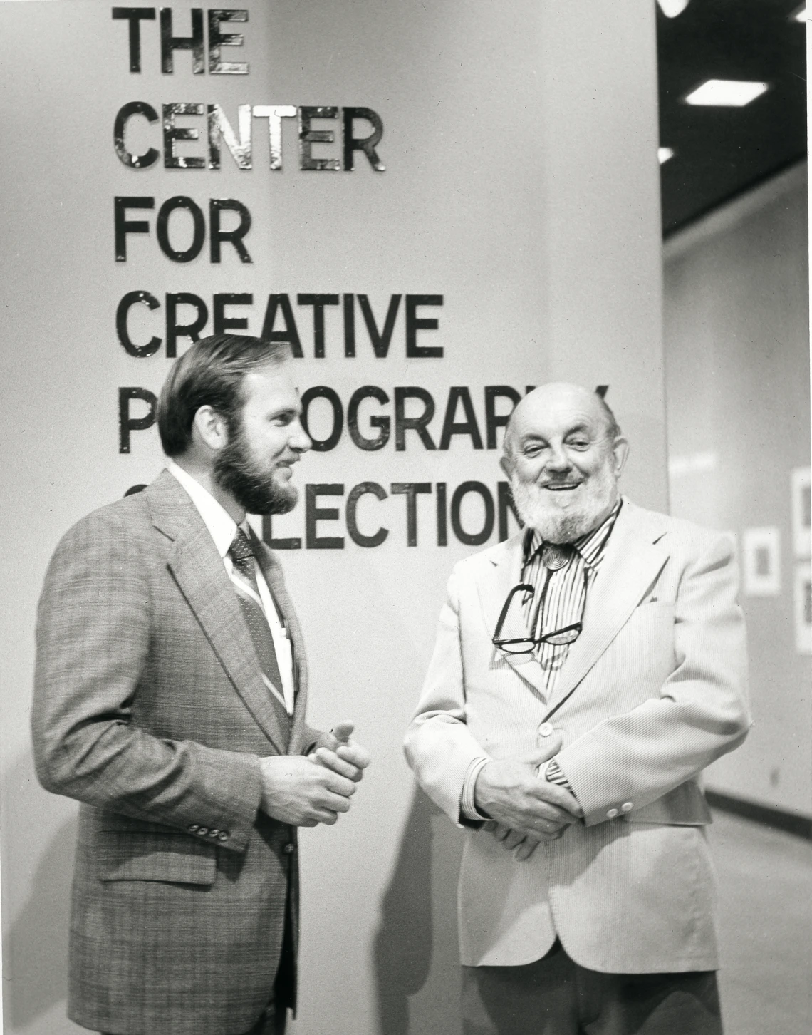 Two men smiling in front of The Center for Creative Photography entrance
