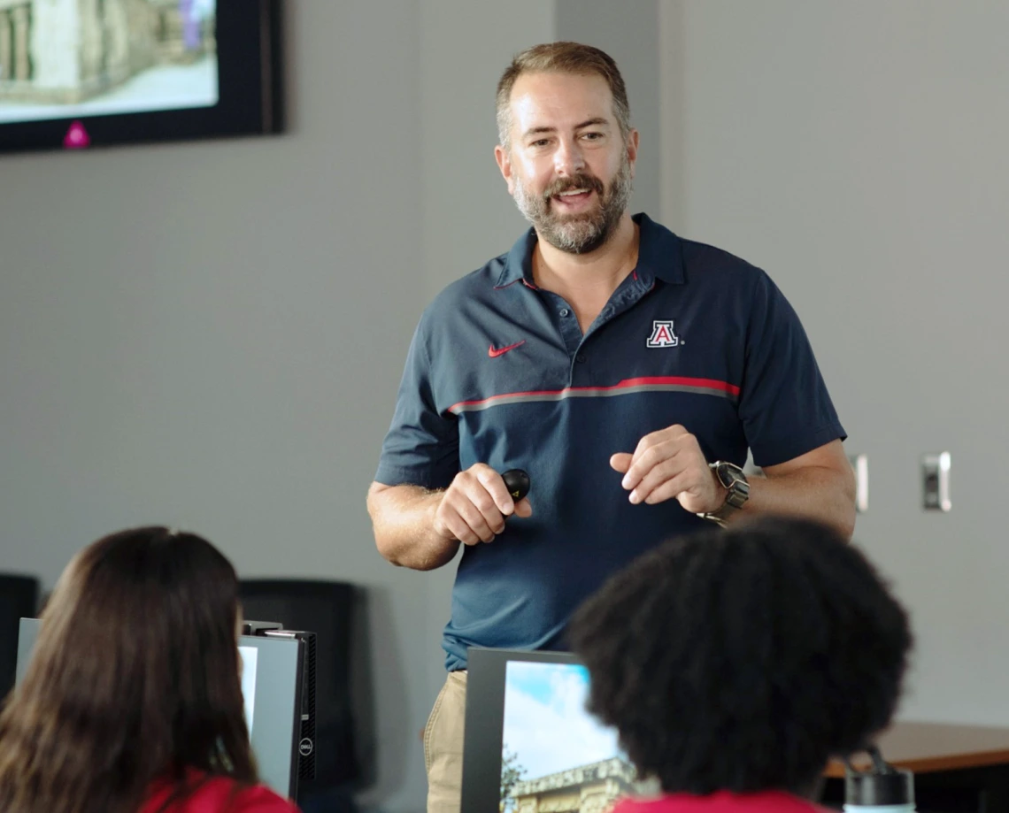 An instructor speaking to a group of students