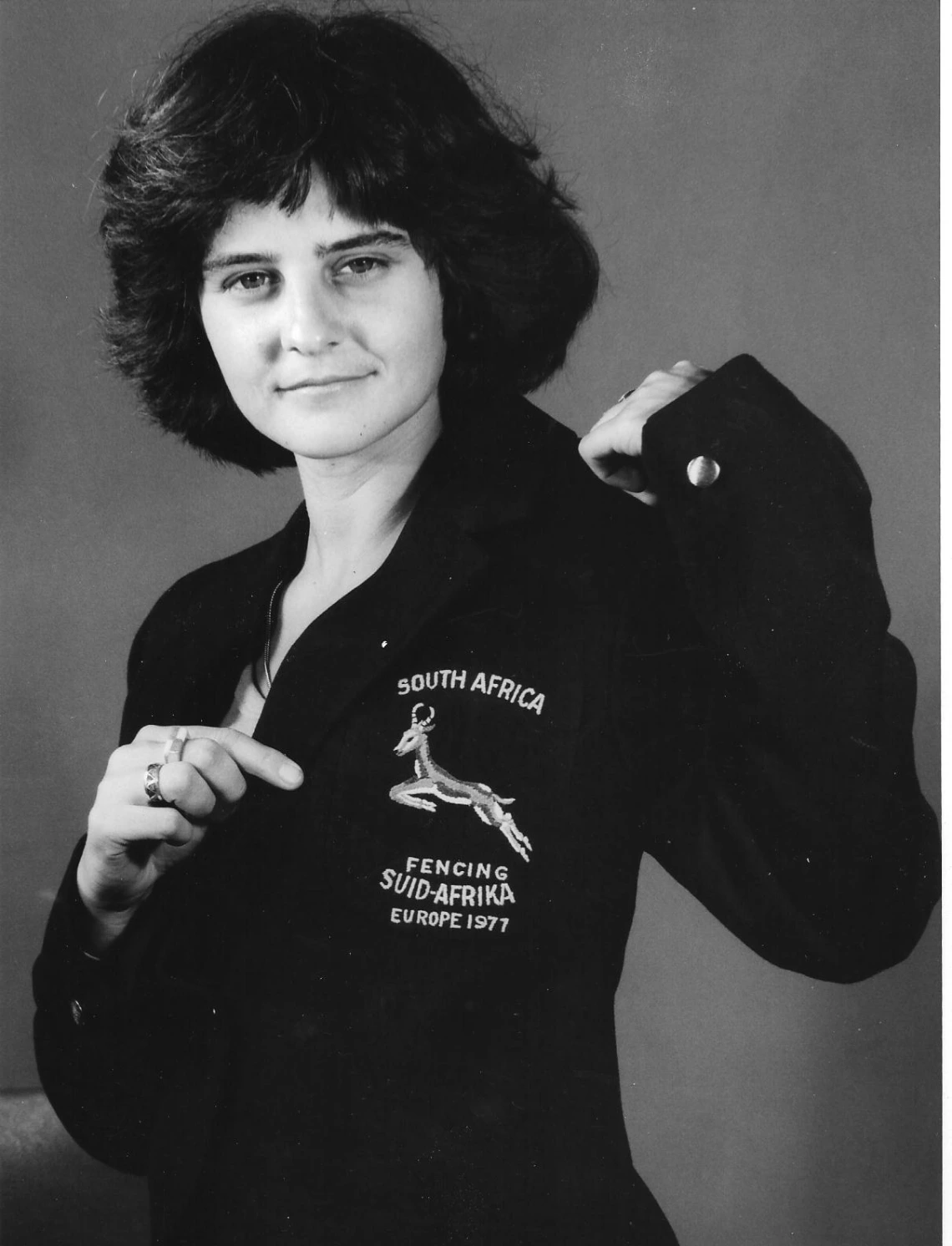 Cathy Kay smiling and showing off her "South Africa Fencing jacket"