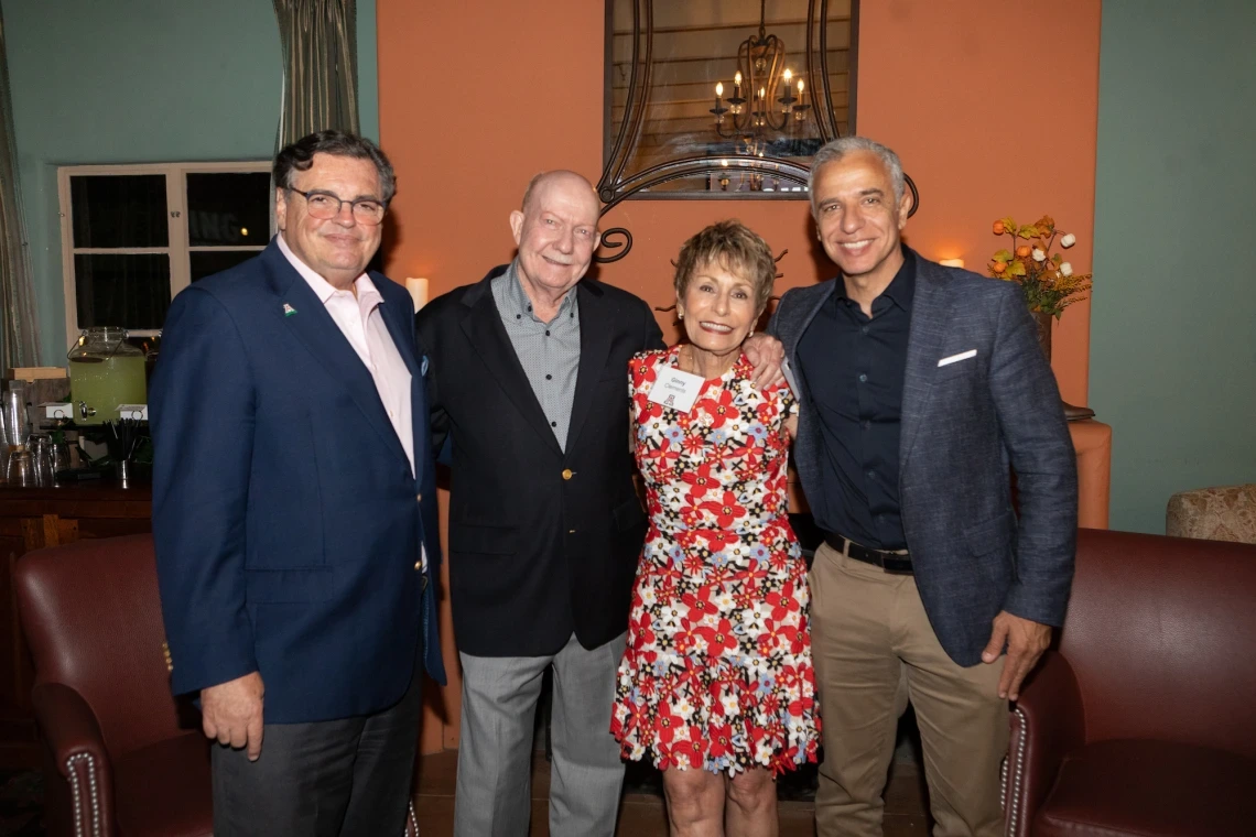 Michael Abecassis, Tom Rogers, Ginny L. Clements and Hesham Sadek standing arm in arm and smiling. 