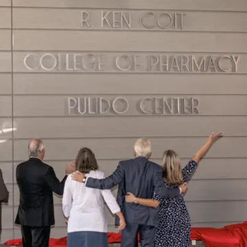 People celebrating a sign