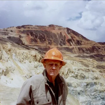 Lowell with hard hat in the field