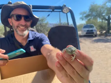 Dr Michael Bogan with a frog