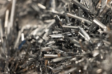 An up-close photograph of silver Stibnite 