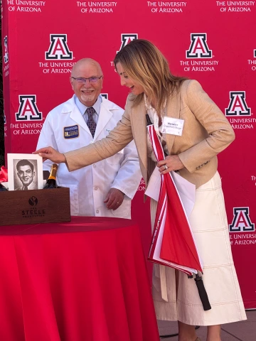 Fayez Ghishan and Marianne Cracchiolo Mago showcasing her father’s U of A graduation photo from 1952.