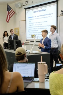 A student lecturing in front of classmates 